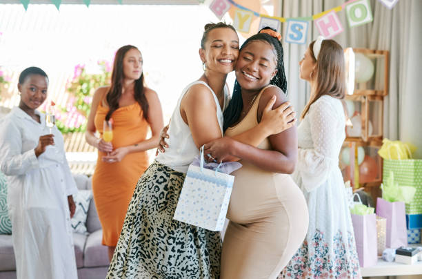 Shot of a pregnant mother to be receiving gifts from her friends at her baby shower Feeling blessed and loved baby shower stock pictures, royalty-free photos & images