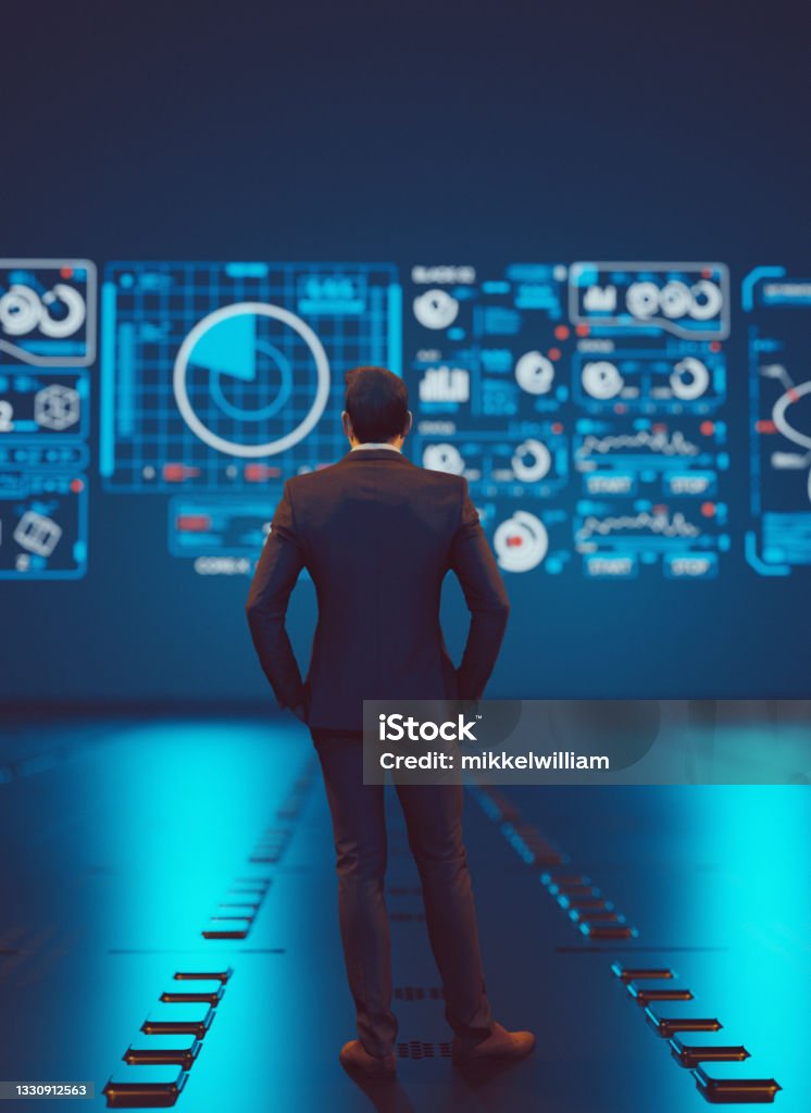 Wathcing big data analysis on hologram screen with symbols Man stands in front of a big hologram screen which has different symbols. He is analyzing data. Concept of data analysis and data complexity. Big Data Stock Photo