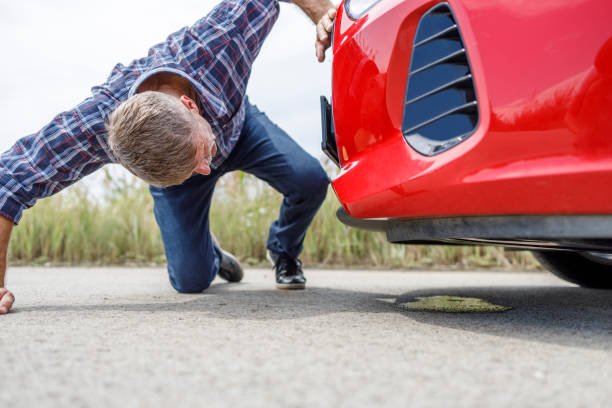 istock Older man trying to look under his car 1330913004