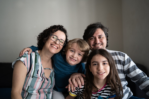 Portrait of happy parents with kids at home