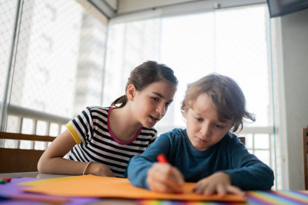 istock Siblings drawing together at home 1330915596