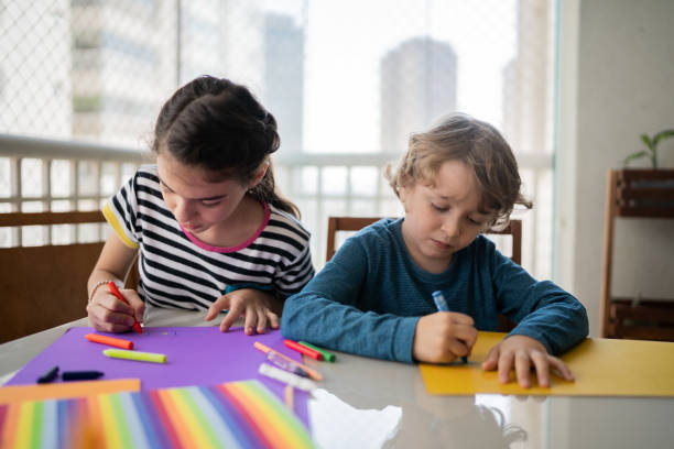 istock Siblings drawing together at home 1330915609