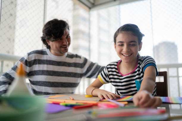 istock Father helping daughter with homework 1330915619