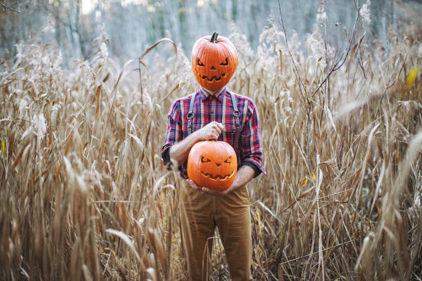 istock Man celebrate halloween with pumpkin on his head 1330917731
