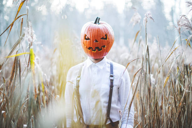 istock Man celebrate halloween with pumpkin on his head 1330917804