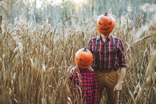 istock Father and son celebrating halloween in forest 1330917875