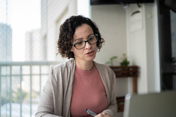 istock Woman doing a virtual business call at home 1330919361