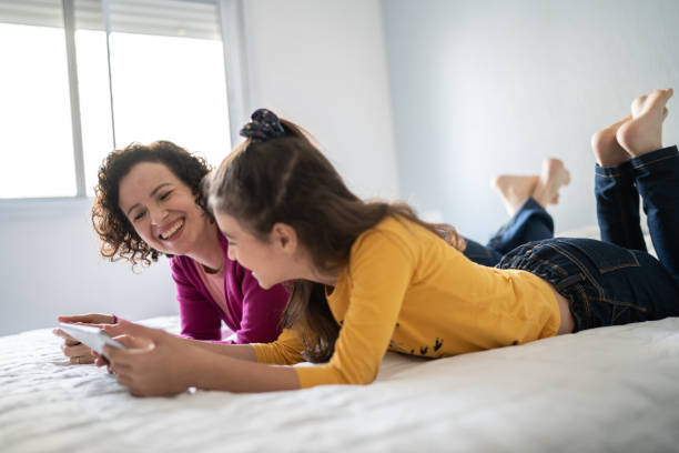 istock Mother and daughter using digital tablet at home 1330919574