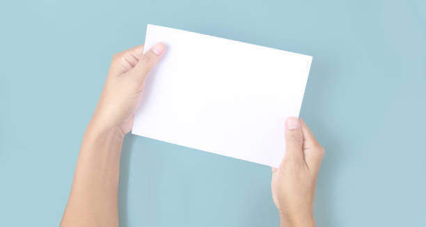 istock Hands holding paper blank for  letter paper 1330919674
