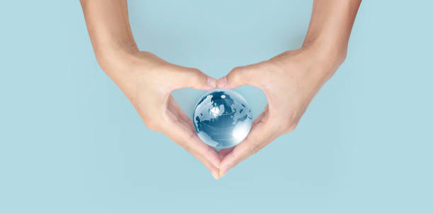 istock Glass globe in hand,Energy saving concept, by NASA 1330919677