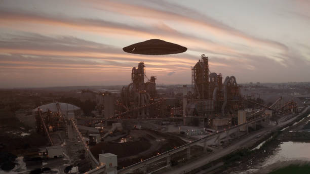 istock Flying saucer hovering over large Factory facility aerial 1330919990