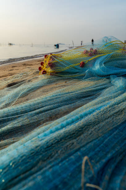 istock Blue fishing net on a beach sand 1330921207