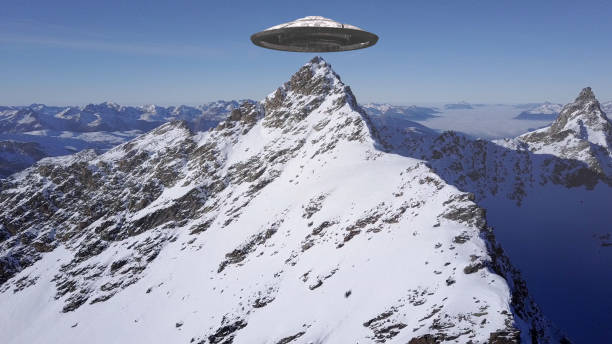 istock Ufo flying saucer over Alps Peak, Aerial view 1330921284