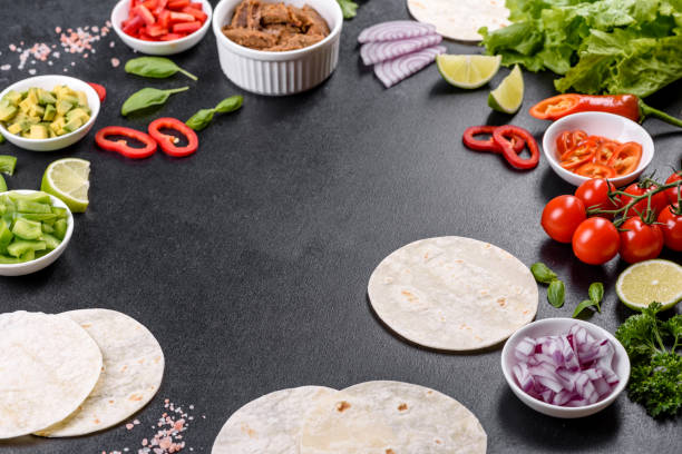 istock Mexican tacos with beef, tomatoes, avocado, onion and salsa sauce 1330924596