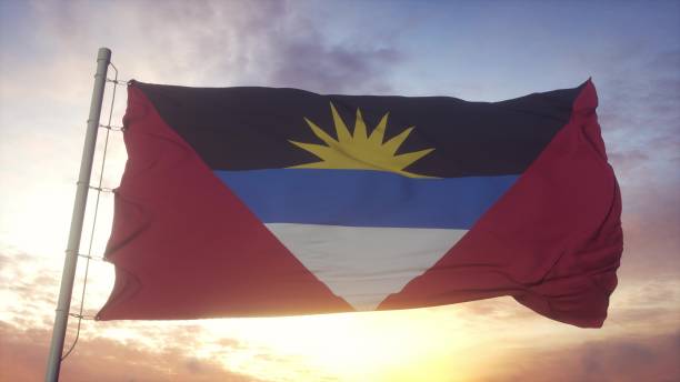 風、空と太陽の背景に手を振るアンティグア・バーブーダの旗。3d レンダリング - flag of antigua and barbuda ストックフォトと画像