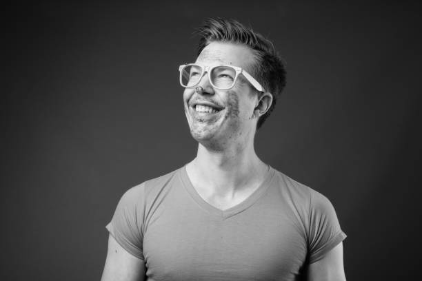 Man in his 50s smiles broadly at the camera, smiling happily.