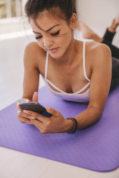 istock Woman relaxing after workout with a cellphone 1330927222