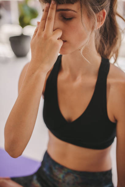 istock Young woman doing breathing exercise 1330927242