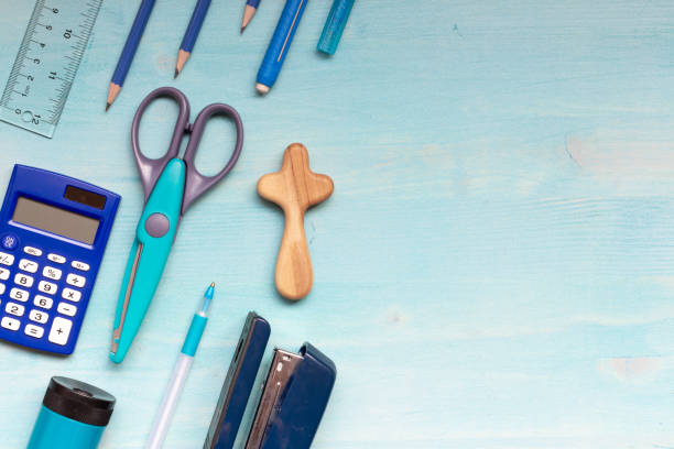 Office and school supplies with cross on blue