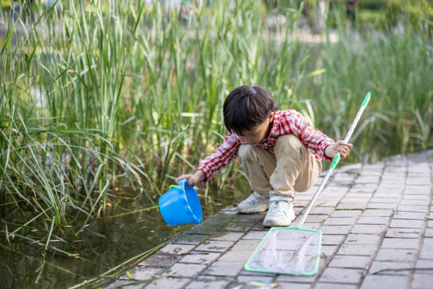 istock A little boy playing by the pond 1330930203