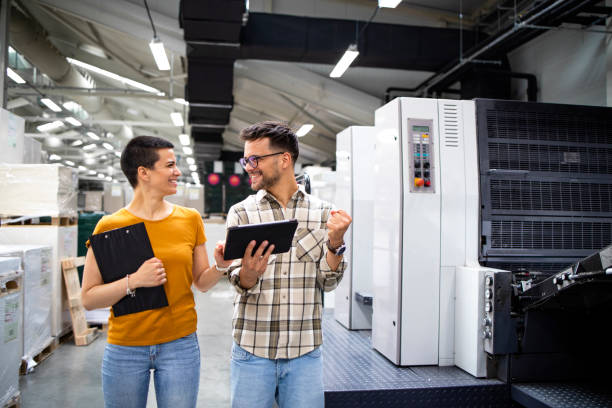 istock Professional graphic designers controlling printing quality in print house. 1330930234