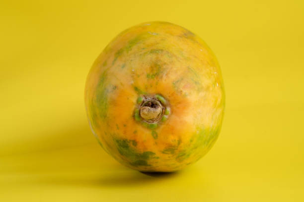istock Papaya on the yellow background 1330932863