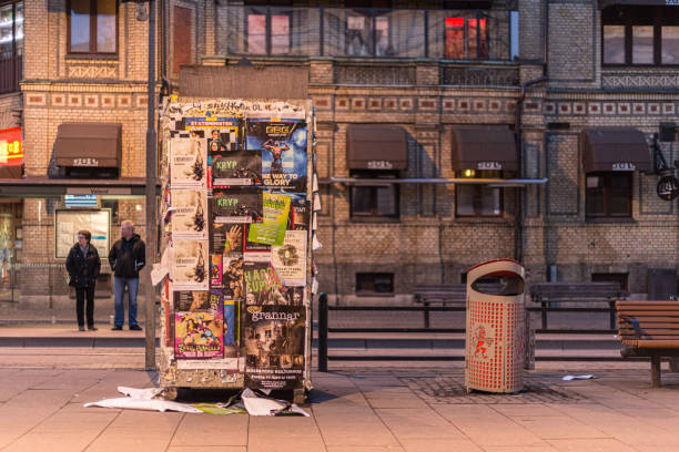 Gothenburg, Sweden - April 07 2014: Poster board and trash can on the street at night.