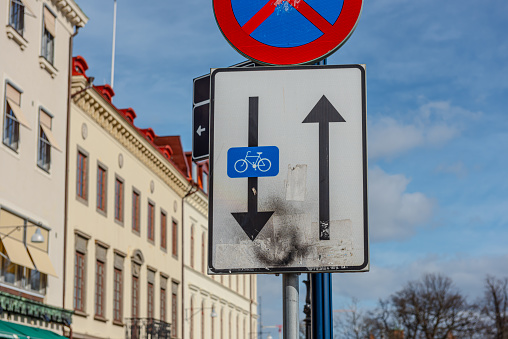 Gothenburg, Sweden - March 21 2021: Sign marking a one way road. Bikes are allowed to travel the oposite way.