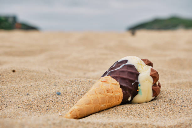 istock Dropped ice cream cone on the sand at Porth Beach, Newquay, Cornwall. 1330934442