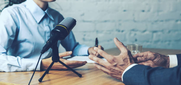 podcast interview recording - radio host discussion with businessman in broadcasting studio. banner copy space stock photo