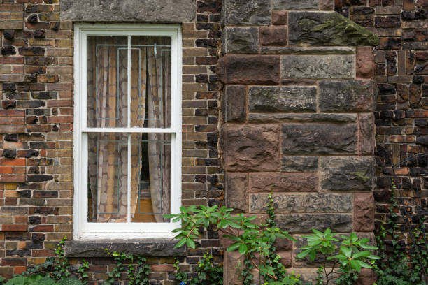 istock View at white window in brown blocks wall 1330934760