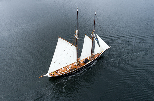SEP 4, 2021: IJSSELMEER, NETHERLANDS: Small traditional classic sailboat sailing under full sails on IJsselmeer lake, Netherlands