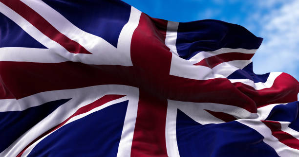 the national flag of the united kingdom flying in the wind. outdoors and sky in the background. - british flag freedom photography english flag imagens e fotografias de stock