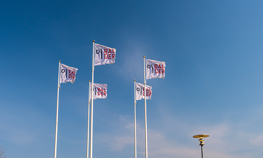 Gothenburg, Sweden - April 18 2021: Five flag poles flying the flag of the Balder company.