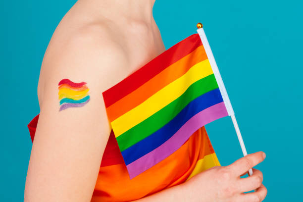 istock young woman covering with lgbt pride flag 1330936018