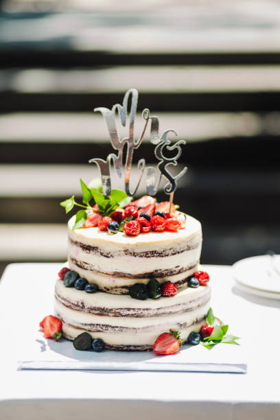 istock Light Buttercream Wedding cake with berries. 1330936785