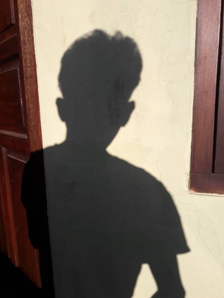 istock man shadow photo with wall background 1330937120
