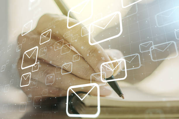 istock Double exposure of postal envelopes hologram with hand writing in notebook on background. Electronic mail and spam concept 1330944958