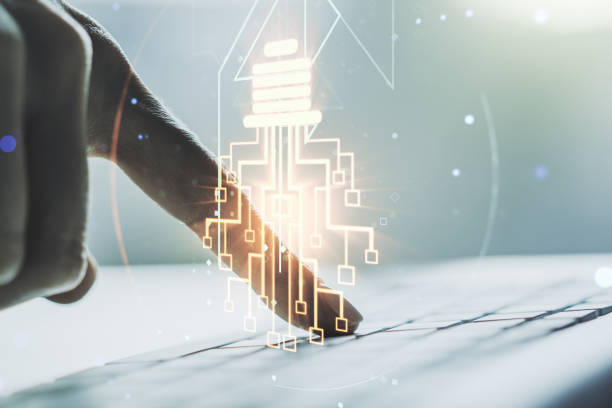 istock Creative light bulb with chip hologram and hands typing on computer keyboard on background, artificial Intelligence and neural networks concept. Multiexposure 1330944968