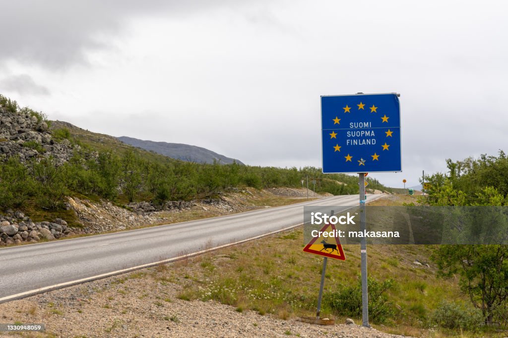 border sign and reindeer crossing sign at the Finnish border in northern Lapland A border sign and reindeer crossing sign at the Finnish border in northern Lapland European Union Stock Photo