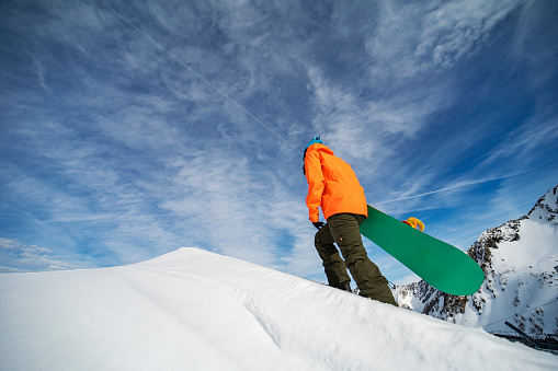 Young woman snowboarding in mountains