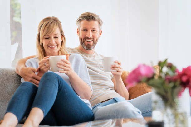 istock Happy couple relaxing at home together 1330949425