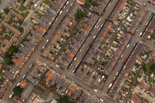 Aerial view looking down onto of rows of terraced houses and streets in a large city showing the blocks of a tight knit neighbourhood or community