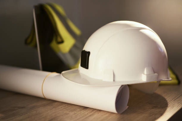 istock Engineering working place: white helmet, plans and laptop 1330952763
