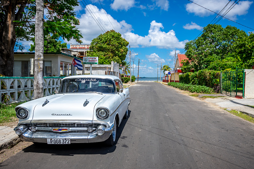 August 6, 2018 - Cienfuegos, Cuba: white vintage car in an empty street of cienfuegos, Cuba