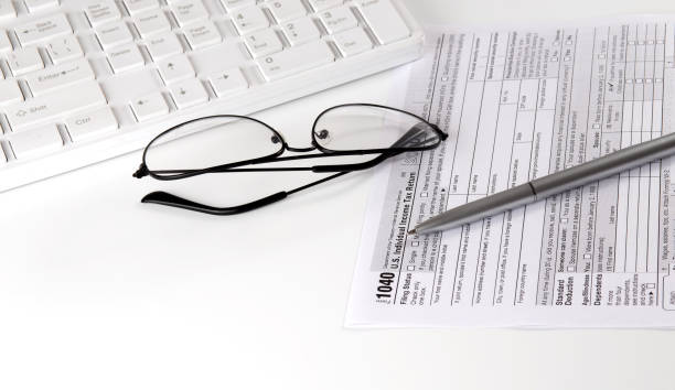 istock New IRS 1040 tax form, instructions, pen and keyboard. Copy space 1330955239