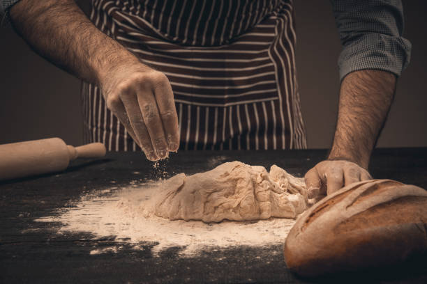 istock Male hands knead the dough. 1330955408