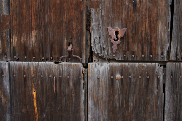 istock Antique wooden door with rusted hardware 1330956405