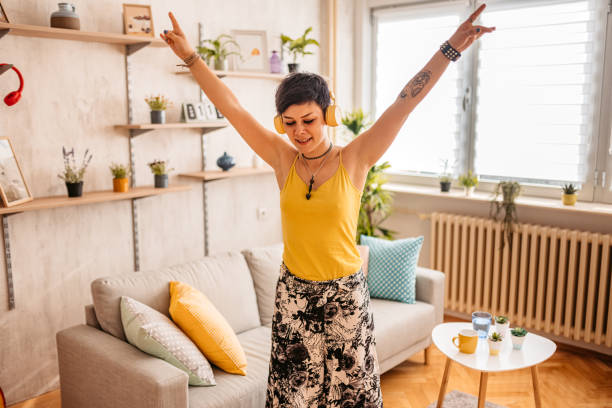 istock Woman singing and dancing at home 1330959079