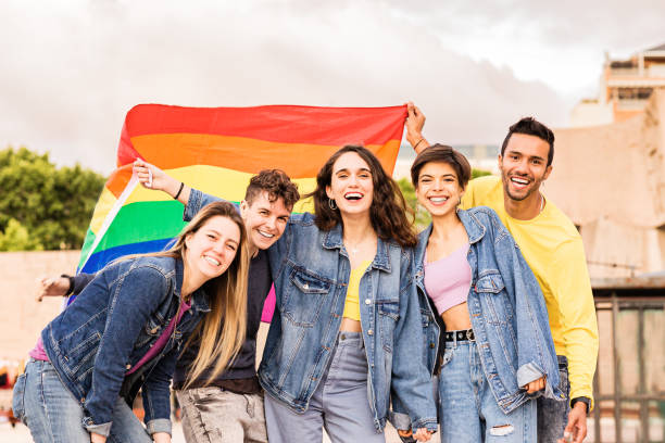 istock Multiethnic diversity LGBTQ group with rainbow flag. friends for gender expression and identity pride. Homosexual, lesbian, bisexual, nonbinary, 1330959228